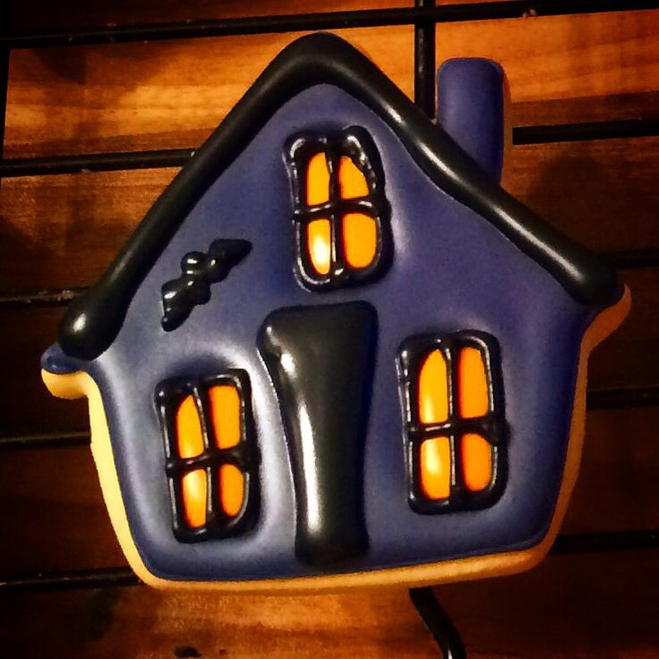 Whimsical House-Shaped Cookie Design with Blue Roof and Orange Windows, Perfect for Festive Nail Art.