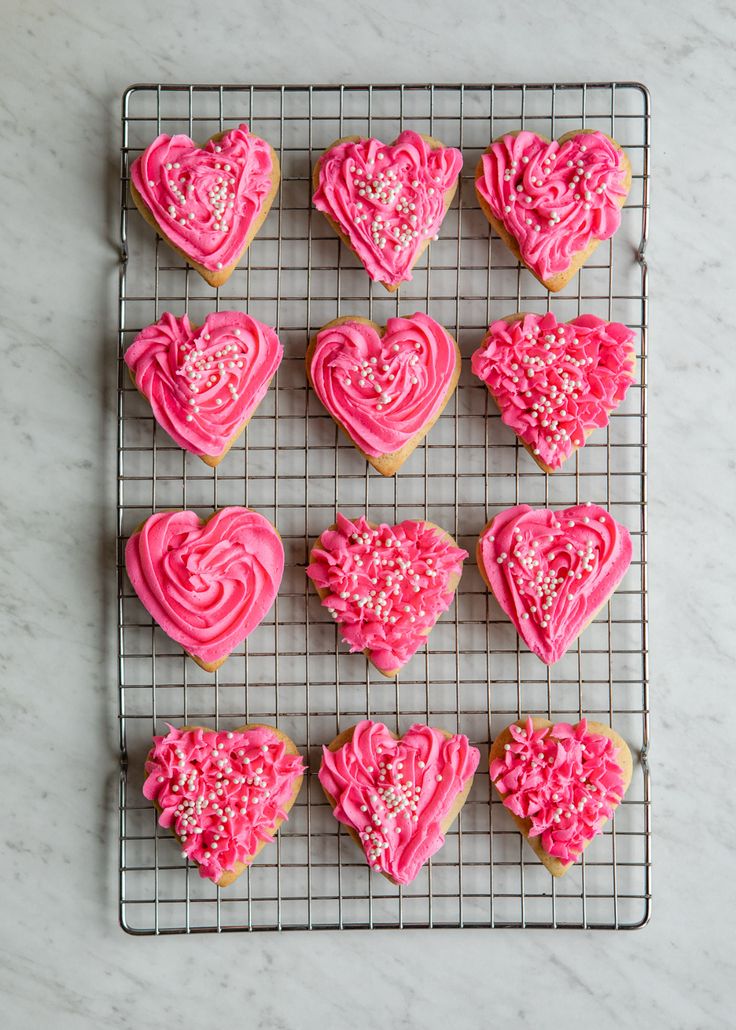 Vibrant Heart-Shaped Cookies with Unique Designs and Decorative Sprinkles for Festive Occasions.