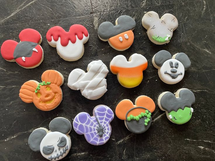 Festive Mickey Mouse-shaped Cookies: Colorful Halloween Designs for Creative Gatherings.