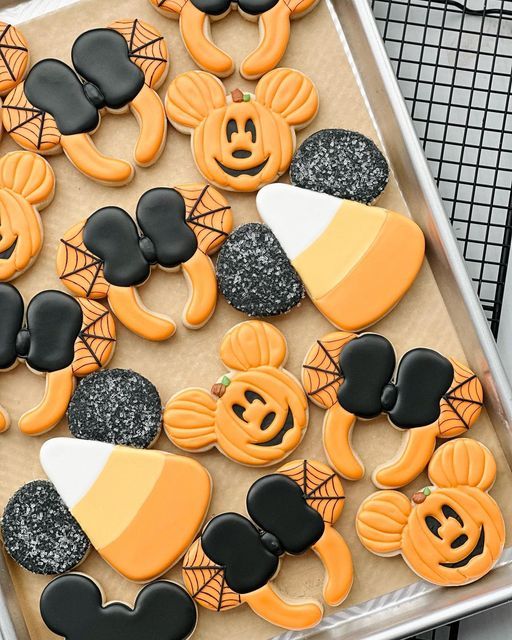 Whimsical Halloween Cookies Featuring Mickey Mouse Pumpkins and Candy Corn Designs.