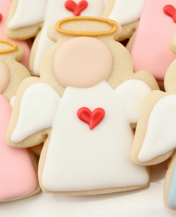 Charming Angel-Shaped Cookies in Soft Pastels with Delicate Details for Festive Celebrations.