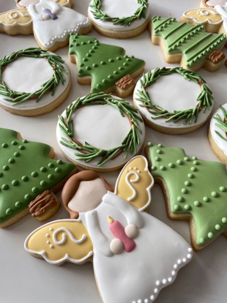 Festive Cookie Decoration Inspiration: Elegant Angel and Christmas Tree Designs with Vibrant Icing.