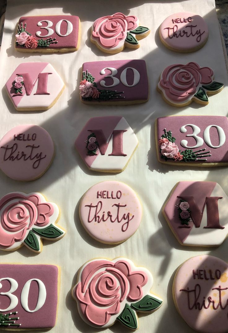 Elegant Floral Cookies: Celebratory Designs with Pink Roses and Green Foliage