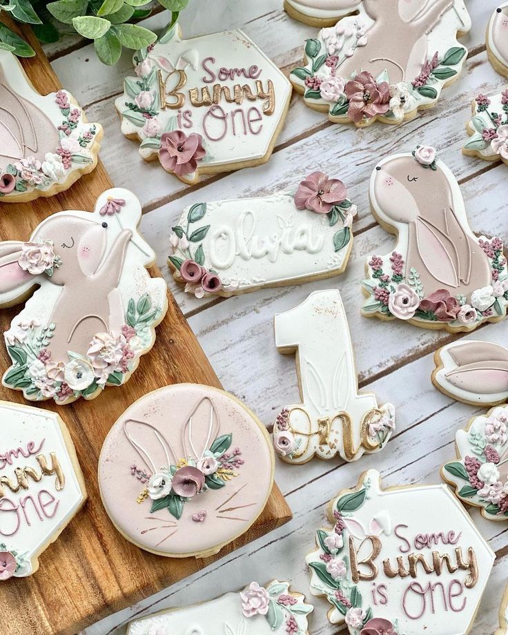 Charming Pastel Cookie Designs with Floral Accents for First Birthday Celebrations.