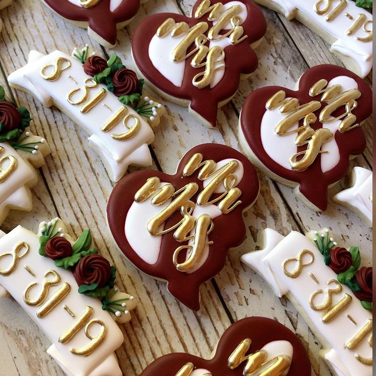 Elegant Wedding Cookies in Burgundy and White with Floral Accents and Gold Lettering.