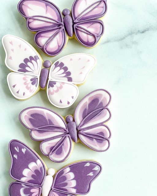 Whimsical Butterfly Nail Art: Delicate Patterns and Soft Purple Hues for Spring and Summer.