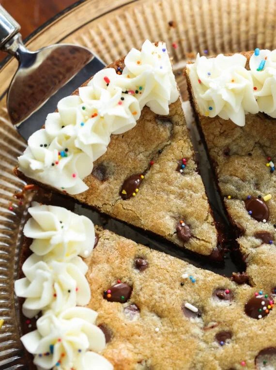 Festive Cookie Cake Delight: Creamy Frosting, Chocolate Chips, and Colorful Sprinkles.