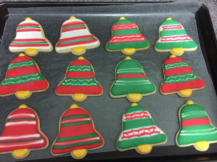 Festive Decorative Christmas Cookies Shaped Like Bells with Intricate Icing Designs.