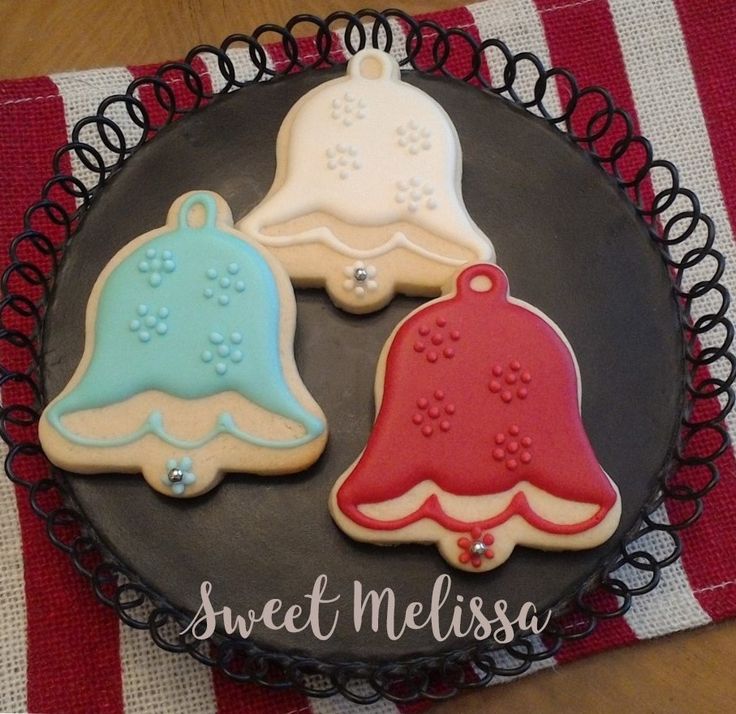 Festive Bell-Shaped Cookies with Glossy Icing and Floral Designs