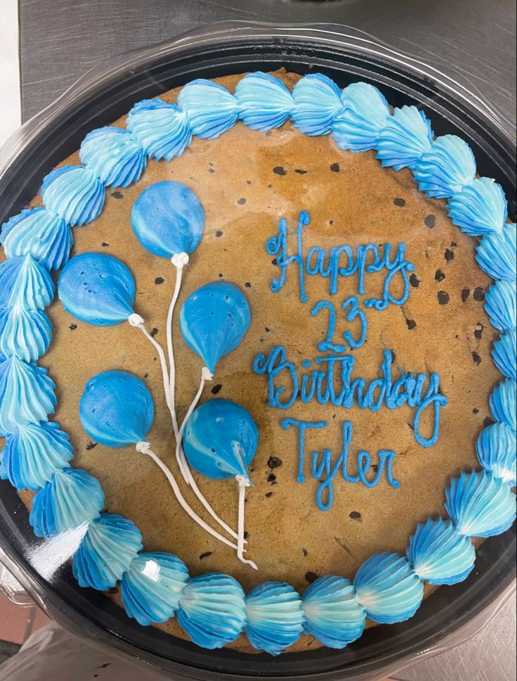 Vibrant Birthday Cake Design with Blue Frosting and Festive Balloon Accents.