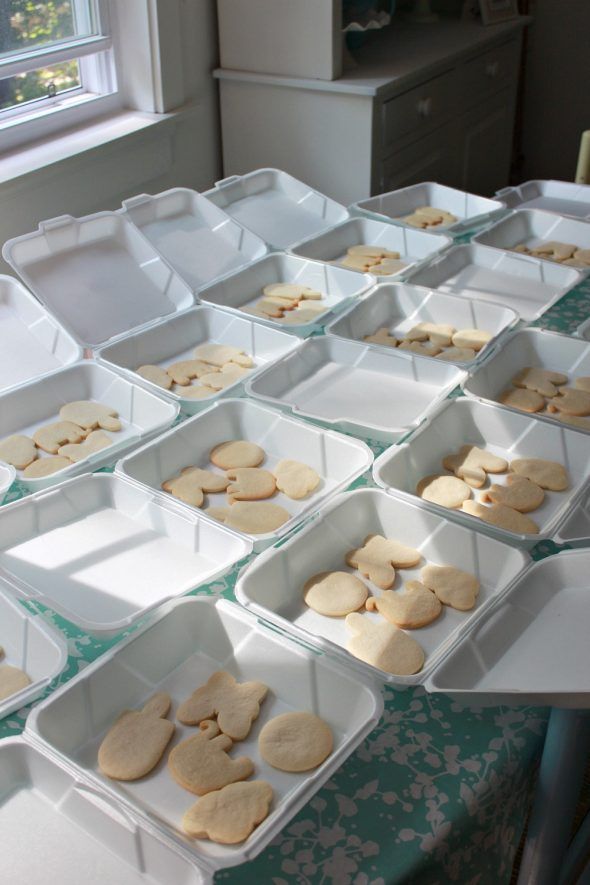 Whimsical Display of Neatly Arranged Cookie Cutouts in White Takeout Containers.