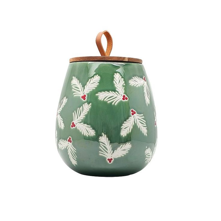 Festive Greenery-Adorned Ceramic Container with Wooden Lid and Leather Loop for Cheerful Holiday Decor.