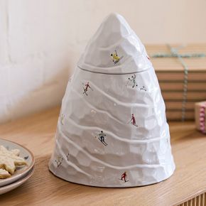 Whimsical Snow-Covered Mountain Ceramic Container with Skier Motifs for Seasonal Decor.