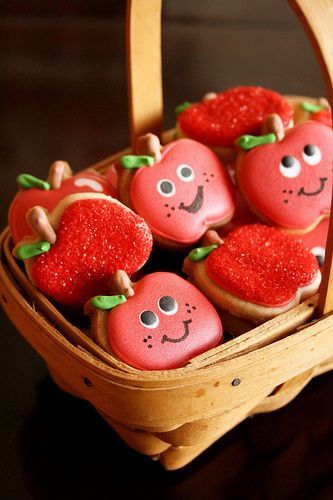 Charming Basket of Colorful Apple-Shaped Cookies with Smiling Faces and Green Leaves.