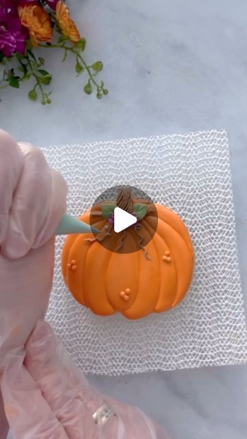 Autumn-Inspired Pumpkin Cake Decoration Technique with Vibrant Icing and Intricate Piping.