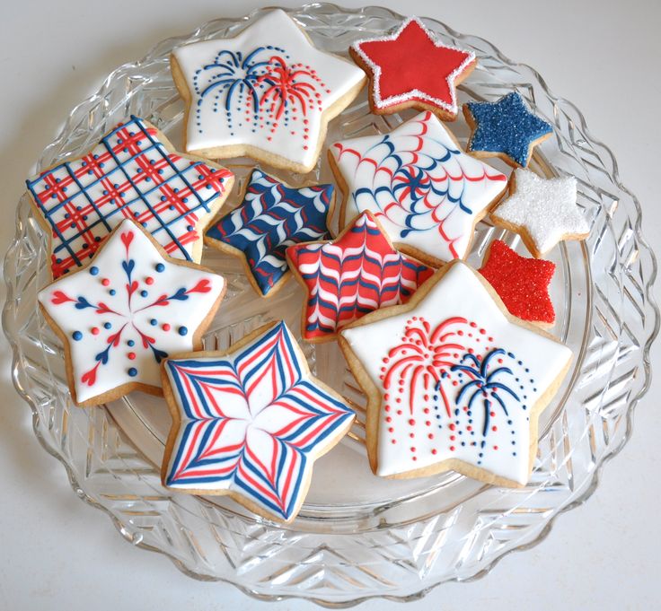 Festive Star-Shaped Cookies with Intricate Red, White, and Blue Designs for Celebrations.