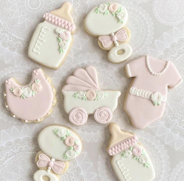 Whimsical Pastel Baby Item Cookies with Floral Designs for Celebrations.