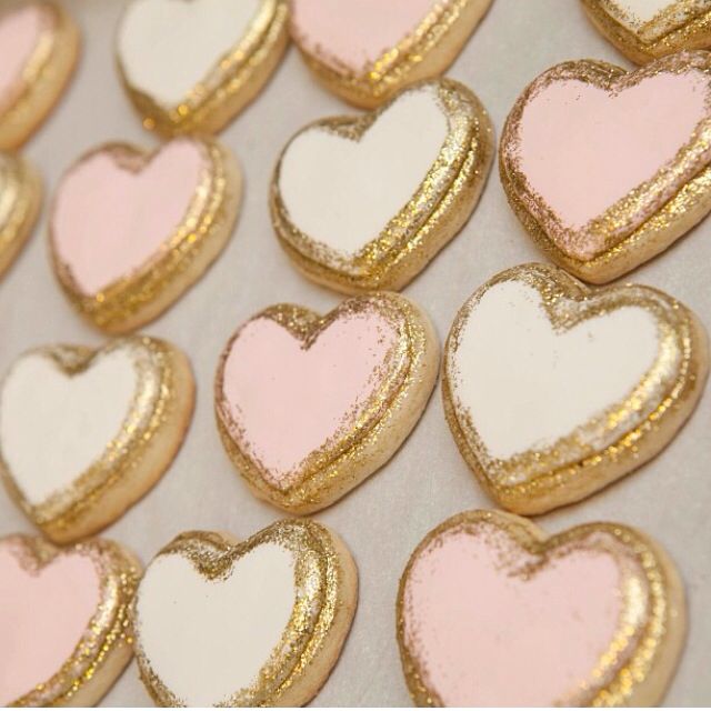 Elegant Heart-Shaped Cookies with Glossy Pink and White Finish for Romantic Occasions.