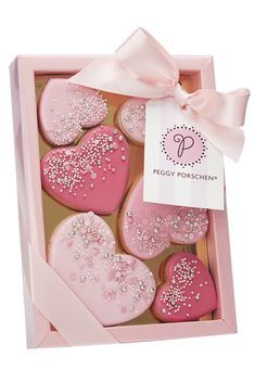 Romantic Heart-Shaped Cookie Box in Pink, Adorned with Icing and Sprinkles for Celebrations.