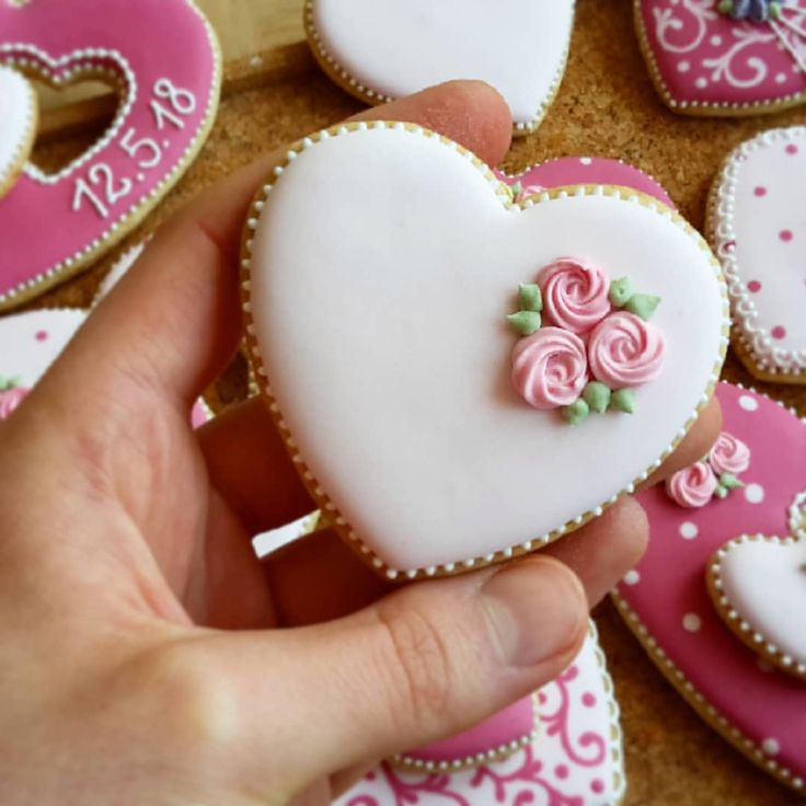 Elegant Heart-Shaped Cookies with Intricate Icing and Charming Accents for Special Occasions.