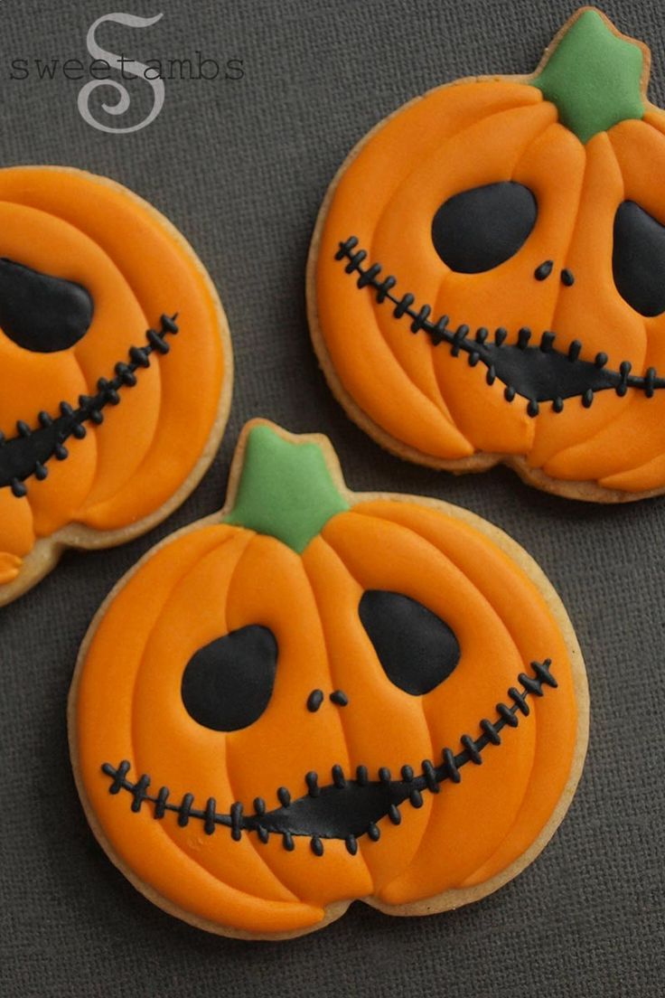 Whimsical Halloween Pumpkin Cookies with Dark Chocolate Accents and Playful Green Tops.