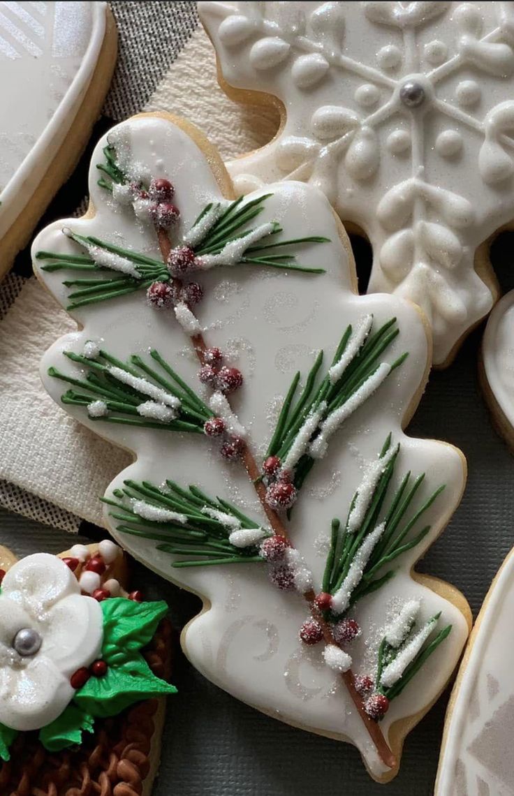 Intricately Designed Leaf-Shaped Festive Cookie with Green Icing, Red Beads, and Icing Sugar Frosting for Holiday Celebrations.