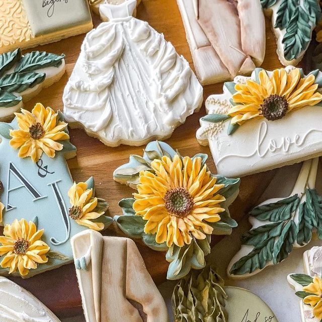 Intricate Floral Decorative Cookies with Vibrant Sunflower Motifs and Romantic Wedding Dress Shapes.