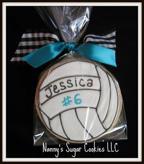 Volleyball-Themed Decorative Sugar Cookie with Elegant Icing and Blue Ribbon.