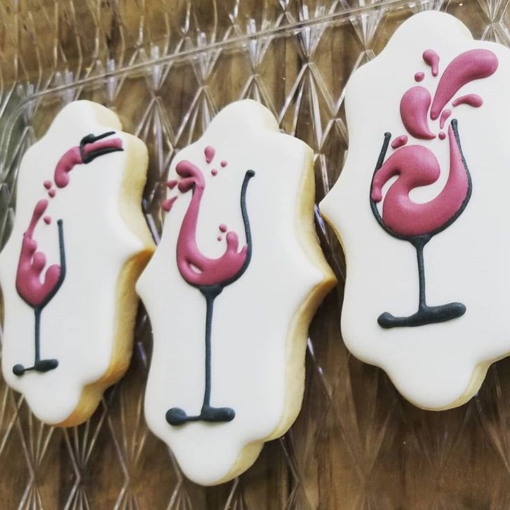 Festive Cookie Designs: Intricate Cocktail Illustrations in Pink and Black Icing.