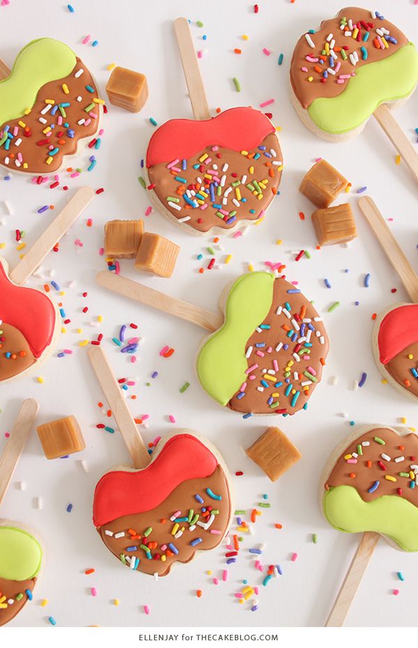 Festive Colorful Cookie Pops with Vibrant Frosting, Sprinkles, and Caramel Cubes.