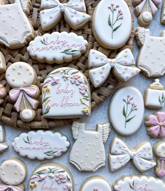 Whimsical Pastel Floral Cookie Designs with Adorable Baby-Inspired Shapes and Intricate Icing Details.