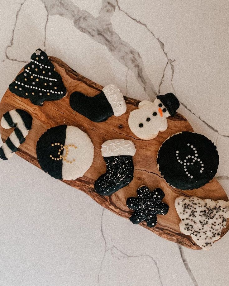 Elegant Festive Cookie Assortment with Holiday Designs on Wooden Platter.