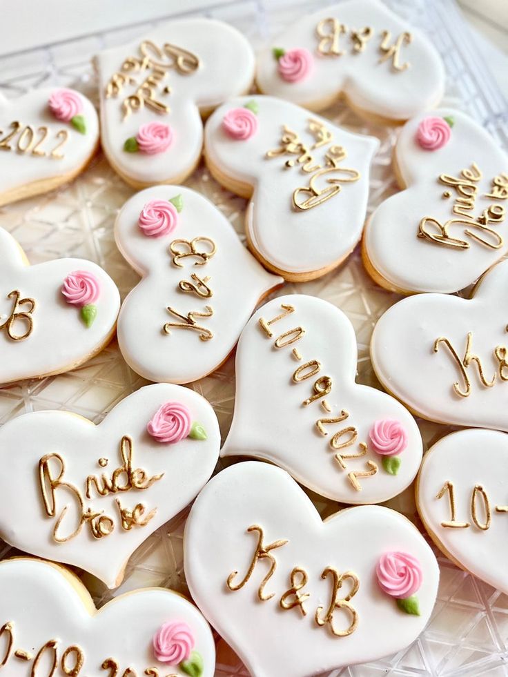 Romantic Heart-Shaped Cookies with Pastel Roses and Elegant Gold Lettering for Special Occasions.