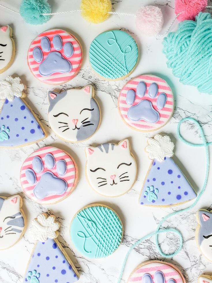 Delightful Cat-Themed Cookies: Cheerful Designs in Pastel Shades for Festive Celebrations.