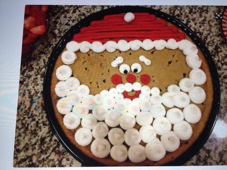 Cheerful Santa Claus Cookie: A Festive Chocolate Chip Delight Decorated with ICings and Candies.