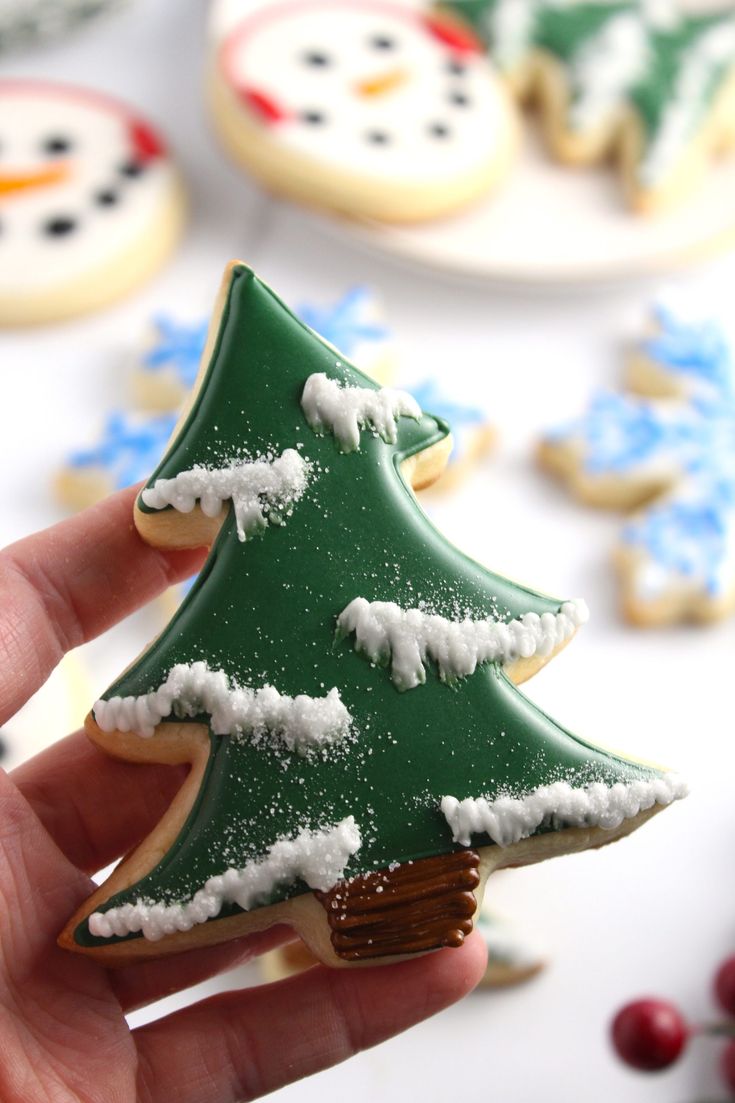 Cheerful Christmas Tree Sugar Cookies with Snowy Accents and Festive Surroundings