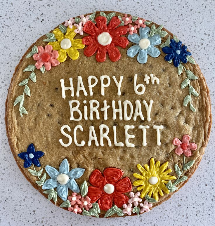 Vibrant Floral Birthday Cookie Design: A Cheerful Celebration of Icing Letters.