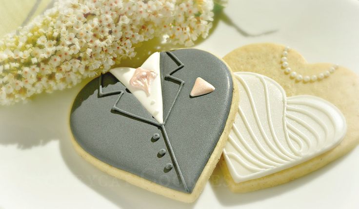 Elegant Wedding-themed Cookies: Heart-shaped Delights with Tuxedo and Gown Designs.