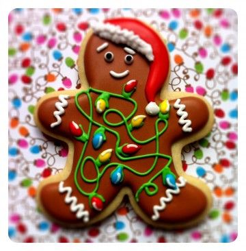 Festive Gingerbread Cookie Design with Santa Hat and Colorful Icing.