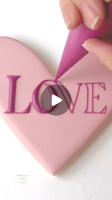 Charming Heart-Shaped Nail Design with Soft Pink Base and Bold Lettering