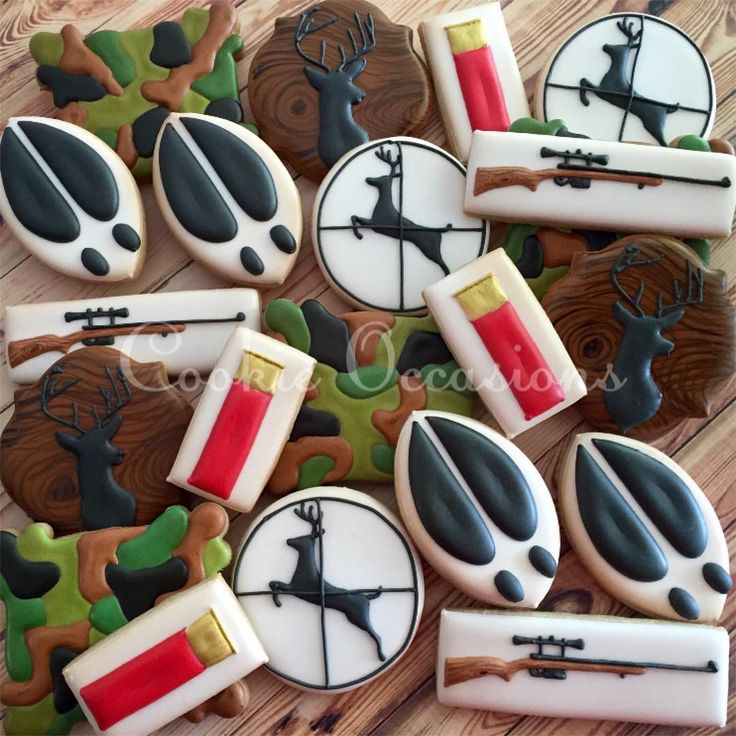 Artistic Hunting-Themed Cookie Designs with Camouflage and Intricate Motifs.