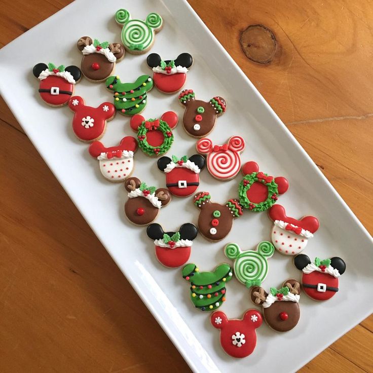 Iconic Holiday-Themed Festive Cookie Designs Featuring Adorable Mickey Mouse Shapes in Vibrant Colors.