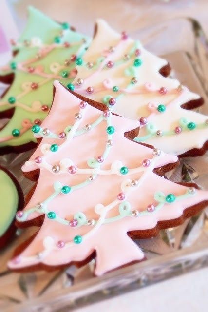 Festive Pastel Iced Christmas Tree Cookies with Intricate Designs and Whimsical Charm.