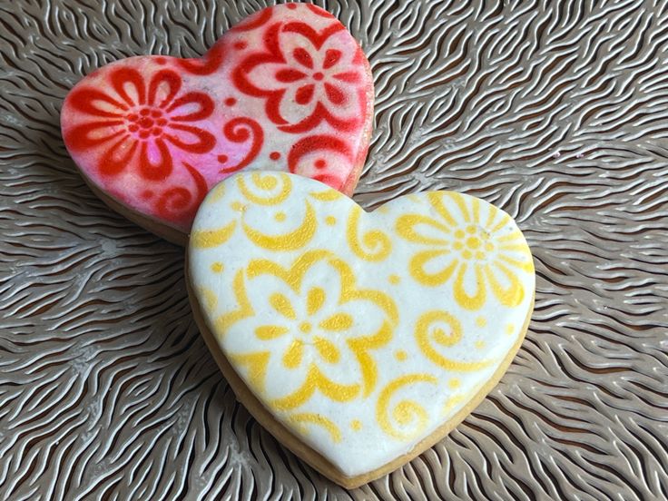 Vibrant Heart-Shaped Cookies Inspire Floral Nail Art for Romantic and Festive Occasions.