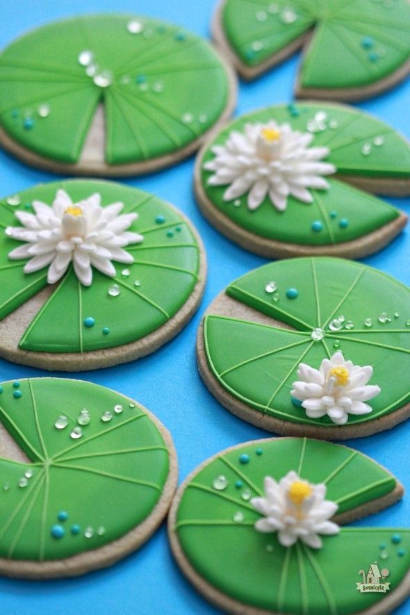 Elegant Lily Pad Cookies with Vivid Green Frosting and Delicate Icing Flowers.