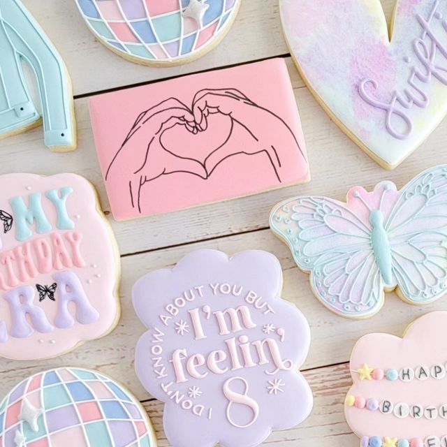 Whimsical Colorful Cookies in Heart and Butterfly Shapes Celebrate with Pastel Hues and Playful Messages