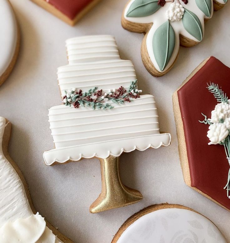 Elegantly Designed Wedding Cake Cookie with Fondant Florals and Complementary Seasonal Cookies.