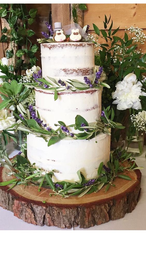 Charming Three-Tiered Wedding Cake with Rustic Lavender and Greenery Decor