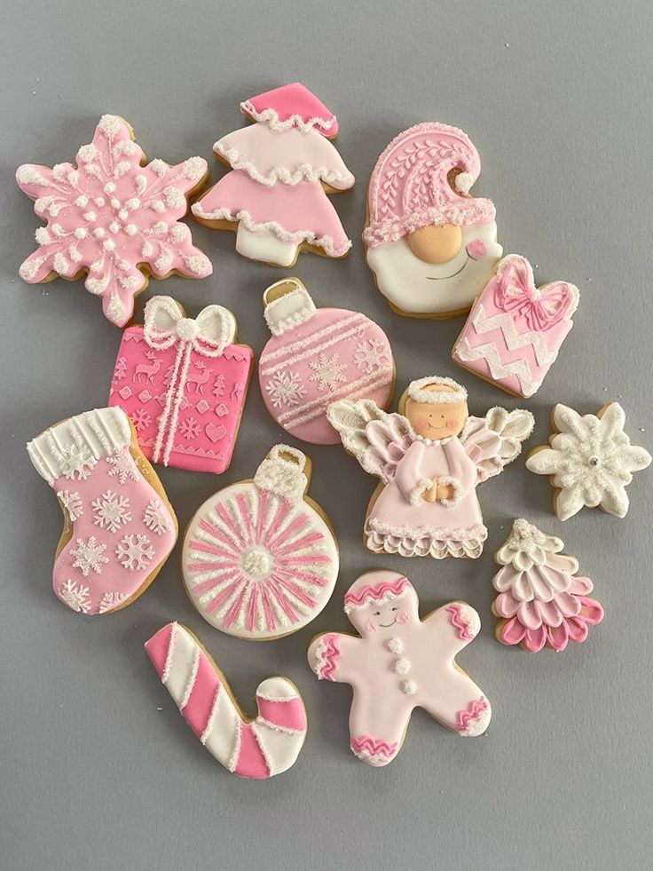 Delightful Winter Wonderland: Charming Holiday Cookies Inspire Cheerful Seasonal Nail Designs in Pastel Pinks and Whites.