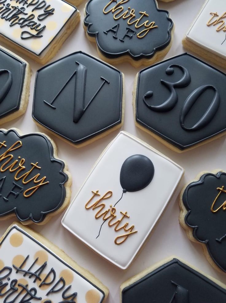 Sophisticated Monochromatic Cookie Designs with Hexagonal Shapes and Gold Accents for Milestone Celebrations